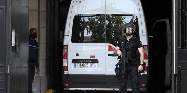 A French Gendarme stands guard next to a prison van transporting Felicien Kabuga, one of the last key fugitives wanted over the 1994 Rwandan genocide, at the Paris court on May 19, 2020.