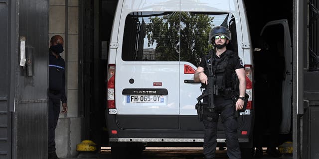 A French Gendarme stands guard next to a prison van transporting Felicien Kabuga, one of the last key fugitives wanted over the 1994 Rwandan genocide, at the Paris court on May 19, 2020.