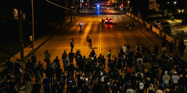 Demonstrators march in the streets on August 26, 2020 in Kenosha, Wisconsin.  After the city declared a state of emergency curfew, a fourth night of civil unrest occurred after the shooting of Jacob Blake, 29, on August 23.