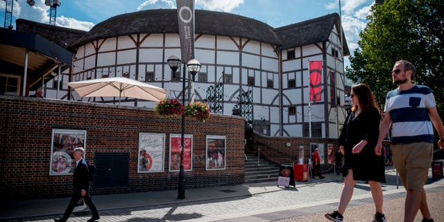 People walk past Shakespeare's Globe Theatre in central London Aug. 24, 2020. 