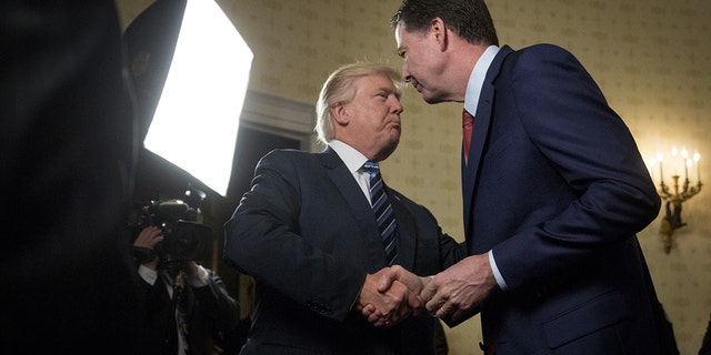 U.S. President Donald Trump 2017 - 2020: U.S. President Donald Trump, left, shakes hands with James Comey, director of the Federal Bureau of Investigation (FBI), during an Inaugural Law Enforcement Officers and First Responders Reception in the Blue Room of the White House in Washington, D.C., U.S., on Sunday, Jan. 22, 2017. 