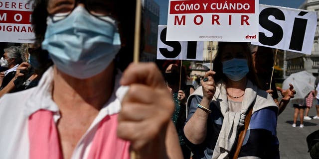 Members of the group "Right to a Decent Death" attend a rally to support the new Spanish Euthanasia Law at Puerta del Sol Square in Madrid