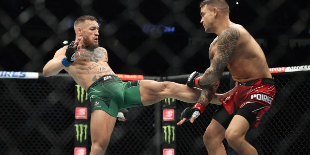 Conor McGregor, left, and Dustin Poirier during their lightweight bout during UFC 264 at T-Mobile Arena in Las Vegas, July 10, 2021.