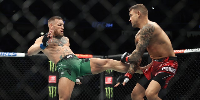 Conor McGregor, left, and Dustin Poirier in their lightweight fight during the UFC 264 event at T-Mobile Arena in Las Vegas, Nevada, USA. 
