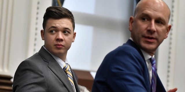 Kyle Rittenhouse, left, and his attorney Corey Chirafisi stand after meeting with Judge Bruce Schroeder for questions on video during jury deliberation at the trial on November 17, 2021, in Kenosha, Wisconsin.