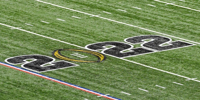The 2022 College Football Playoff logo on the field before the Alabama Crimson Tide face the Georgia Bulldogs in the national championship Jan. 10, 2022, at Lucas Oil Stadium in Indianapolis.