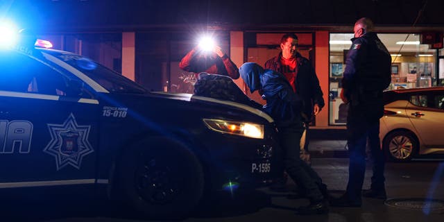 Police officers arrest a resident on suspicion of burglary in Tijuana, Mexico, Thursday, February 10, 2022. 