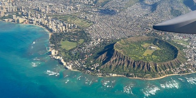 An aerial view from the window of a plane shows Diamond Head crater in Oahu, Hawaii on February 23, 2022. 