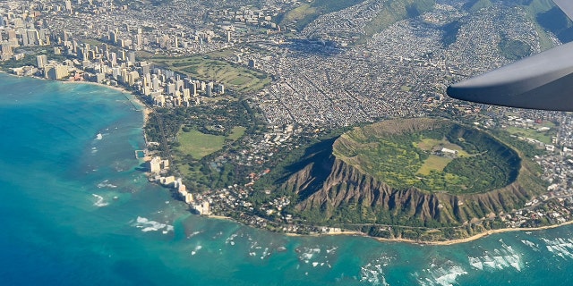 An aerial view from the window of a plane shows Diamond Head crater in Oahu, Hawaii on February 23, 2022. 