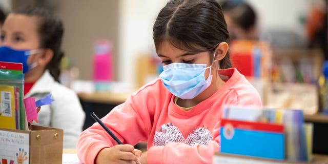 Students in Isabel Reyes kindergarten class at Stanley Mosk Elementary School in Winnetka, California, wear masks while indoors Friday, March 11, 2022. 