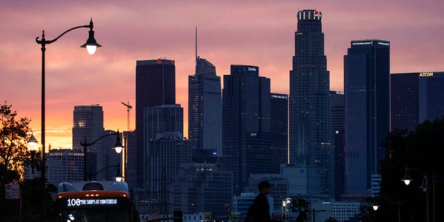 A glowing sky provides a colorful backdrop to the downtown Los Angeles skyline as seen from Boyle Heights on Tuesday, March 15, 2022 in Boyle Heights, CA. 