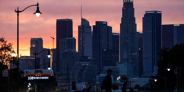 A glowing sky provides a colorful backdrop to the downtown Los Angeles skyline as seen from Boyle Heights on Tuesday, March 15, 2022, in Boyle Heights, CA. 