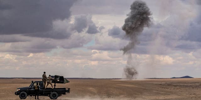 Troops from the Syrian Democratic Forces (SDF) Special Operations and the US-led anti-jihadist coalition, take part in heavy-weaponry military exercises in the countryside of Deir Ezzor in northeastern Syria, on March 25, 2022. 