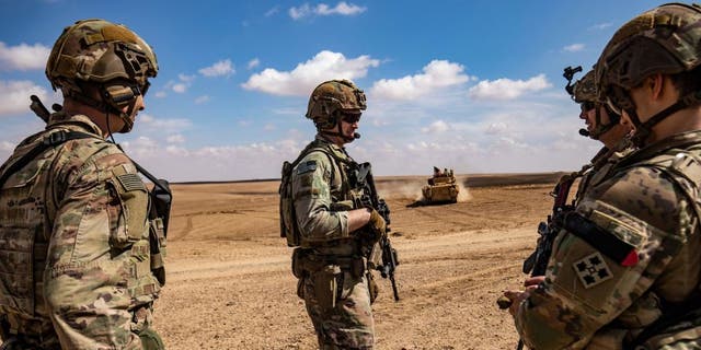 Forces of the Syrian Democratic Forces (SDF) Special Operations and US-led anti-jihadist coalition take part in a heavy weapons military exercise in the countryside of Deir Ezzor, northeastern Syria, March 25, 2022.