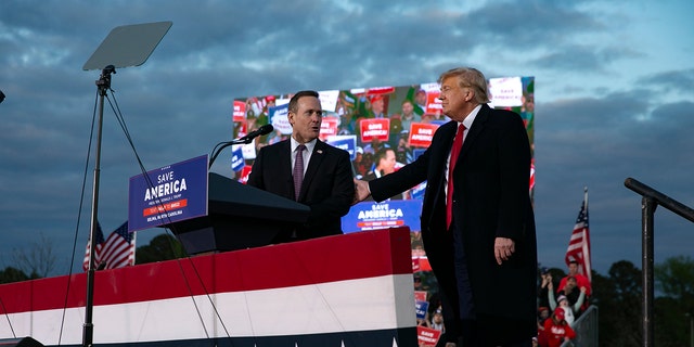 Ted Budd, who is running for U.S. Senate, joins the stage with former U.S. President Donald Trump during a rally at The Farm at 95 on April 9, 2022, in Selma, North Carolina. 