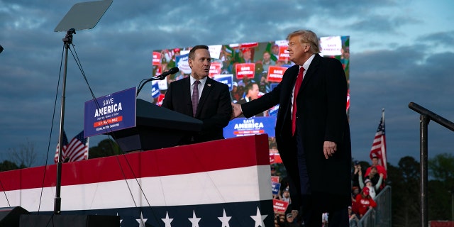 Ted Budd, who is running for U.S. Senate, joins the stage with former U.S. President Donald Trump during a rally at The Farm at 95 on April 9, 2022 in Selma, North Carolina. 