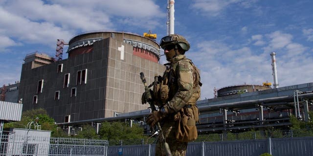 TOPSHOT - A Russian serviceman patrols the territory of the Zaporizhzhia Nuclear Power Station in Energodar on May 1, 2022. - The Zaporizhzhia Nuclear Power Station in southeastern Ukraine is the largest nuclear power plant in Europe and among the 10 largest in the world. (ANDREY BORODULIN/AFP via Getty Images)
