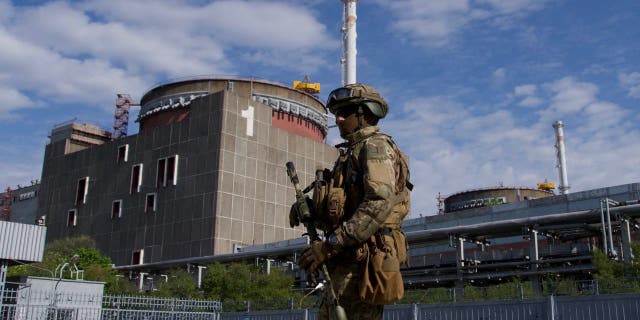 A Russian serviceman patrols the territory of the Zaporizhzhia Nuclear Power Station in Energodar on May 1, 2022.