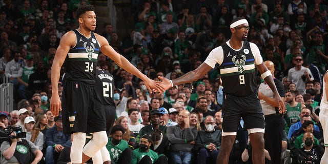 Milwaukee Bucks' Bobby Portis #9 hi-fives Giannis Antetokounmpo #34 during Game 5 of the 2022 NBA Playoff Eastern Conference Semifinals on May 11, 2022 at TD Garden in Boston, Massachusetts.  