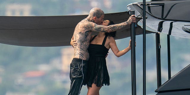 Travis Barker and Kourtney Kardashian kiss on a yacht in Portofino, Italy.