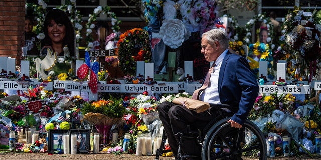 Texas Gov. Greg Abbott arrives while President Joe Biden and First Lady Jill Biden pay their respects at a makeshift memorial outside of Robb Elementary School in Uvalde, Texas, on May 29, 2022.