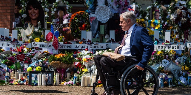 Texas Gov. Greg Abbott arrives while President Joe Biden and First Lady Jill Biden pay their respects at a makeshift memorial outside of Robb Elementary School in Uvalde, Texas, on May 29, 2022.