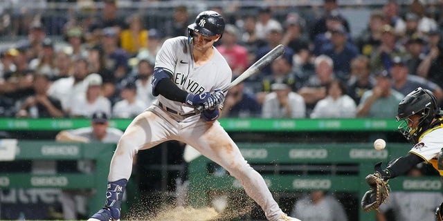 Joey Gallo #13 of the New York Yankees holds back his swing after the ball clashes into the dirt during the eighth inning against the Pittsburgh Pirates on July 6, 2022 at PNC Park in Pittsburgh, PA. 