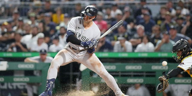 Joey Gallo #13 of the New York Yankees holds back his swing after the ball clashes into the dirt during the eighth inning against the Pittsburgh Pirates on July 6, 2022 at PNC Park in Pittsburgh, PA.
