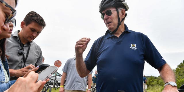US President Joe Biden stops to talk to reporters during a bike ride in Gordon's Pond State Park in Rehoboth Beach, Delaware on July 10, 2022. (Photo by Nicholas Kamm / AFP) (Photo by NICHOLAS KAMM/AFP via Getty Images)