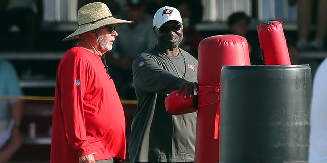 Tampa Bay Buccaneers senior adviser and former head coach Bruce Arians, left, and new head coach Todd Bowles talk during Buccaneers training camp at AdventHealth Training Center in Tampa, Florida, on July 29, 2022.