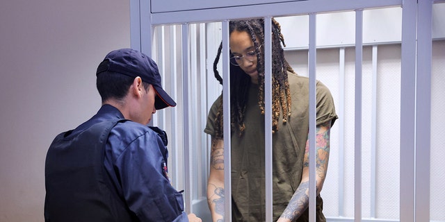 US basketball player Brittney Griner stands in her defendant's cage before a court hearing during her trial on drug smuggling charges in the Moscow suburb of Khimki on August 2, 2022.