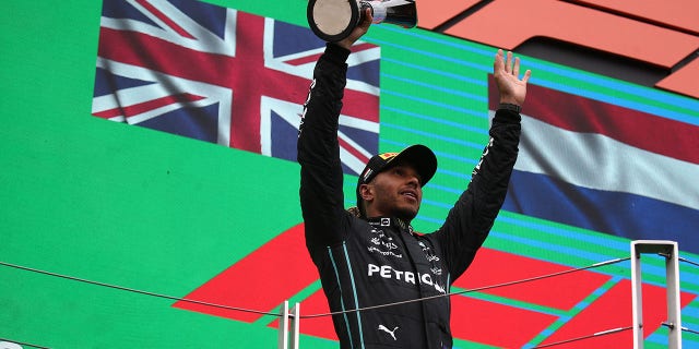 Lewis Hamilton of the Mercedes AMG Petronas F1 Team celebrates on the podium at the end of the F1 Grand Prix of Hungary.