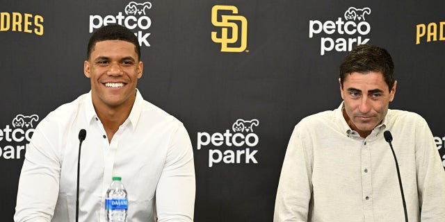 Juan Soto, left, of the San Diego Padres and GM A.J. Preller answer questions during a news conference to introduce Soto August 3, 2022, at Petco Park in San Diego. 