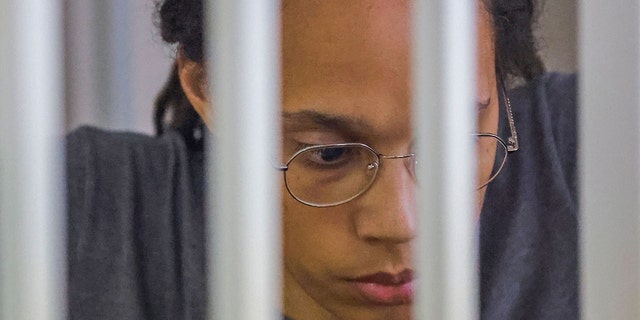 WNBA basketball player Britney Greiner, who was arrested at Moscow's Sheremetyevo Airport and later charged with illegal cannabis possession, sits inside a cage for defendants following a court ruling during a hearing in Khimki outside Moscow, on August 4, 2022. 