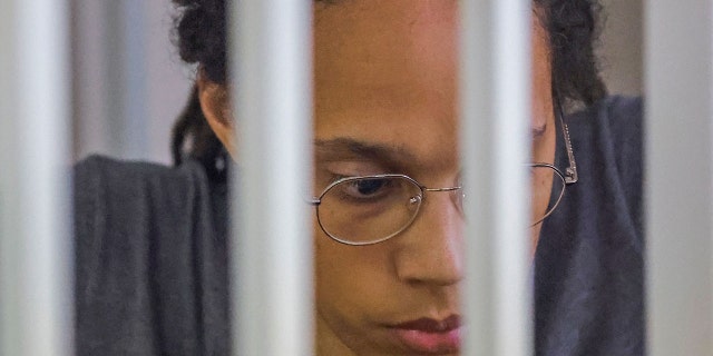 WNBA basketball player Brittney Griner, who was detained at Moscow's Sheremetyevo airport and later charged with illegal possession of cannabis, sits inside a defendants' cage after the court's verdict during a hearing in Khimki outside Moscow, on August 4, 2022.
