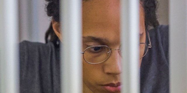 WNBA basketball player Brittney Griner, who was detained at Moscow's Sheremetyevo airport and later charged with illegal possession of cannabis, sits inside a defendants' cage after the court's verdict during a hearing in Khimki outside Moscow, on August 4, 2022. 