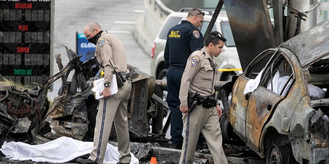 CHP and other officials investigate a fiery crash where multiple people were killed near a Windsor Hills gas station at the intersection of West Slauson and South La Brea avenues on Aug. 4, 2022, in Los Angeles, California.