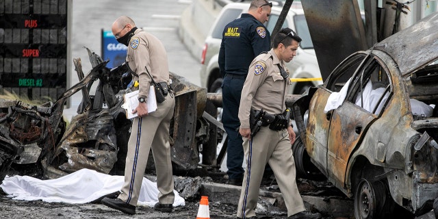 CHP and other officials investigate a fiery crash where multiple people were killed near a Windsor Hills gas station at the intersection of West Slauson and South La Brea avenues on Aug. 4, 2022, in Los Angeles, California.