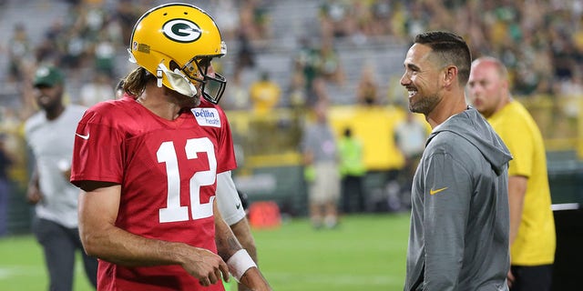 Green Bay Packers quarterback Aaron Rodgers (12) and Green Bay Packers head coach Matt LaFleur laugh during Green Bay Packers Family Night at Lambeau Field, Aug. 5, 2022, in Green Bay, Wis. 