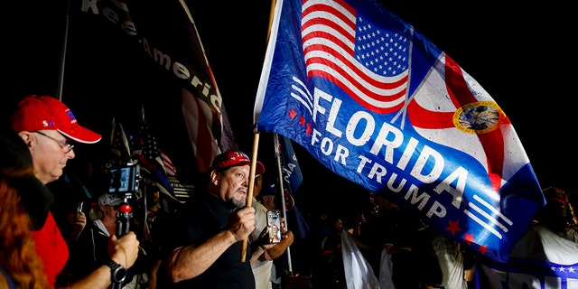 Supporters of former President Trump rally near his home at Mar-A-Lago Aug. 8, 2022, in Palm Beach, Fla. The FBI raided the home to retrieve classified White House documents. 