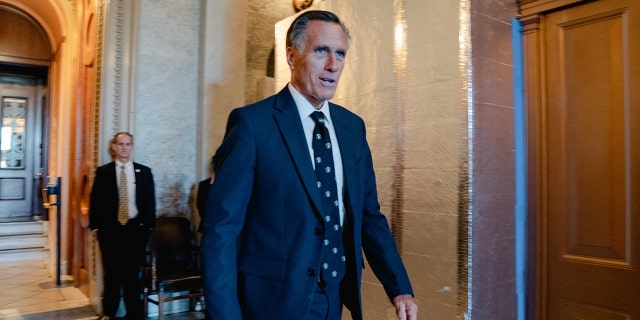 FILE - Mitt Romney, R-Utah, exits the Senate Chamber during amendment votes, also called the "vote-a-rama", on the Inflation Reduction Act on Capitol Hill in Washington, D.C. on August 7, 2022. 