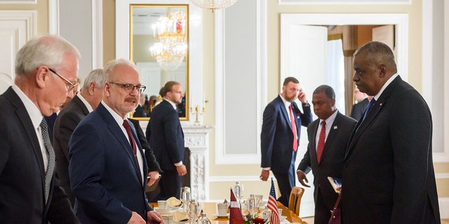 Latvia's President Egils Levits, second left, and U.S. Secretary of Defense Lloyd Austin, right, take seat for talks during a visit in Riga, Latvia, on August 10, 2022. 