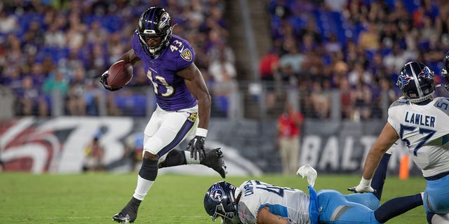 Baltimore Ravens' Justice Hill runs out of the backfield during an NFL preseason game against the Tennessee Titans at M and T Bank Stadium on August 11, 2022 in Baltimore, Maryland.