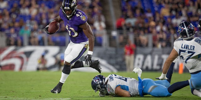 Baltimore Ravens' Justice Hill runs out of the backfield during an NFL preseason game against the Tennessee Titans at M and T Bank Stadium on August 11, 2022 in Baltimore, Maryland.