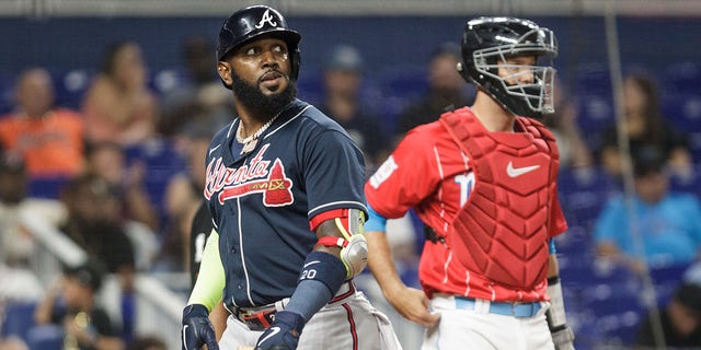 Marcell Ozuna, left, of the Atlanta Braves, reacts after striking out during the second inning against the Miami Marlins at loanDepot Park Aug. 13, 2022, in Miami, Fla. 