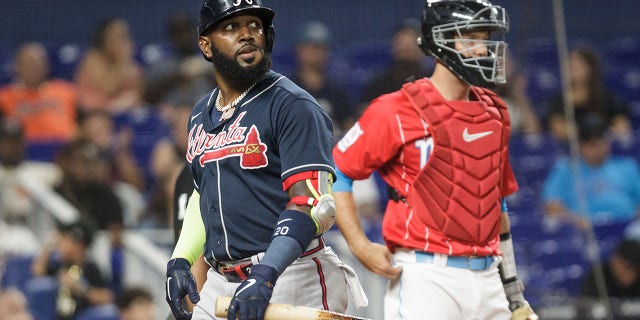 Marcell Ozuna, left, of the Atlanta Braves, reacts after striking out during the second inning against the Miami Marlins at loanDepot Park Aug. 13, 2022, in Miami, Fla. 