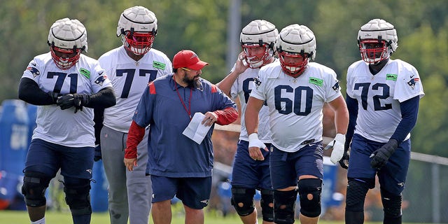 New England Patriots offensive line coach Matt Patricia and, from left, Mike Onwenu, Trent Brown, Cole Strange, David Andrews  and Yodny Cajuste during training camp at Gillette Stadium on Aug. 15, 2022, in Foxboro.