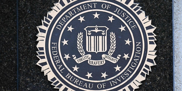 The seal of the Federal Bureau of Investigation is seen outside of its headquarters in Washington, DC on August 15, 2022. - Threats against the FBI and law enforcement agencies have increased following the search and seizure of top secret documents from former US president Donald Trump's Mar-a-Lago estate where he resides.