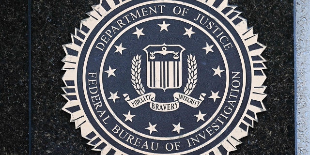 The seal of the Federal Bureau of Investigation is seen outside of its headquarters in Washington, DC on August 15, 2022. - Threats against the FBI and law enforcement agencies have increased following the search and seizure of top secret documents from former US president Donald Trump's Mar-a-Lago estate where he resides. 