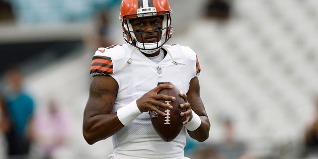 Cleveland Browns quarterback Deshaun Watson, #4, stands on the field during a preseason game between the Cleveland Browns and the Jacksonville Jaguars on Aug. 12, 2022 at TIAA Bank Field in Jacksonville, Florida.